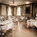 Luxurious dining room with elegant table setting and chandelier, ideal for fine dining events.